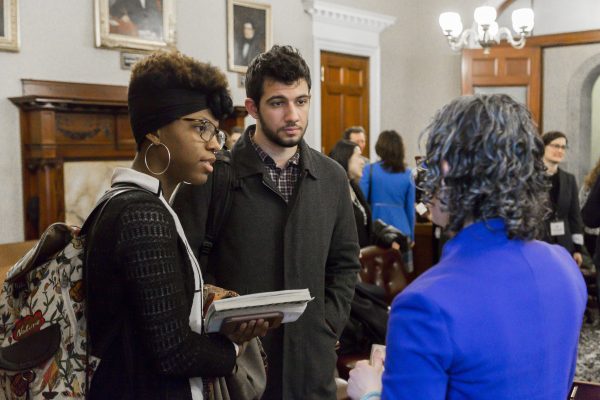MAPC Government Affairs Manager Lizzi Weyant talks with a young man and woman at the State of Equity Agenda release event