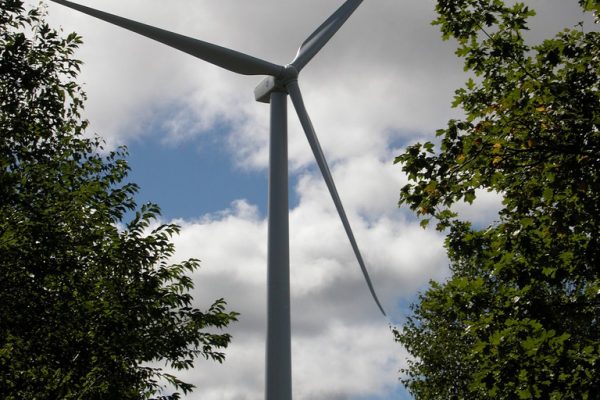wind turbine against a blue sky and white clouds