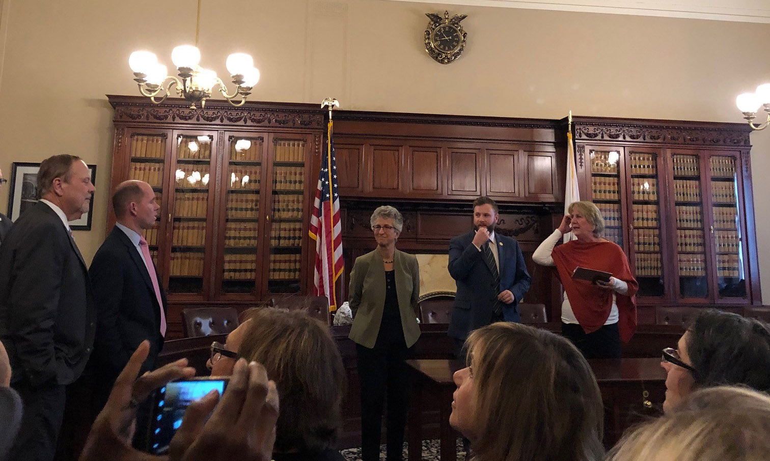 Speakers stand at the front of the room at the Cultural Caucus briefing