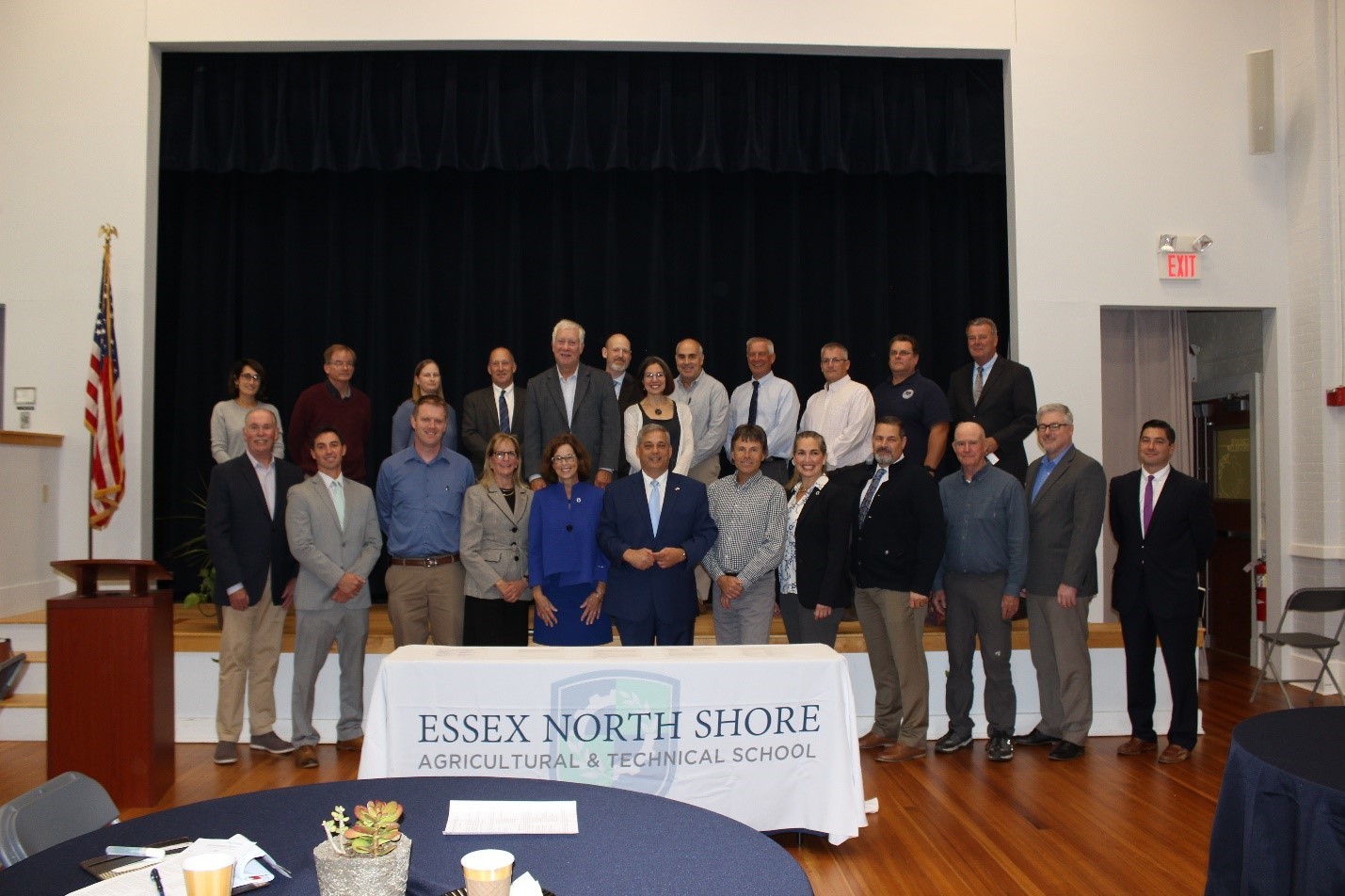 North Shore Water Resiliency Task Force A bunch of people standing infront of a large, black chalkboard in a large room. They are facing the camera smiling.