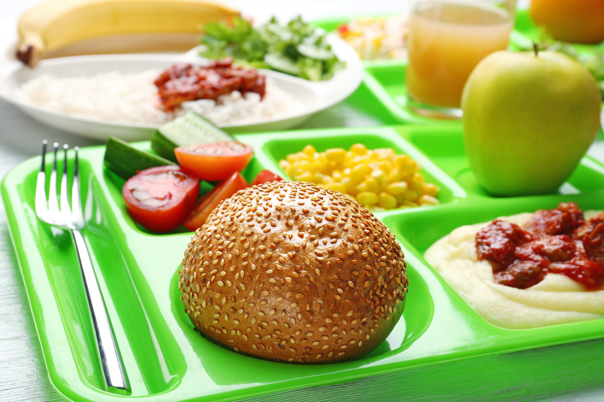 A close up of a serving tray with various healthy types of food on it. Concept is a school lunch.