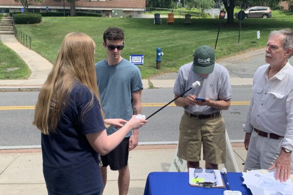 A photo of a volunteer picking up the sensors at FSU and an FSU member is demonstrating how to use the sensor.