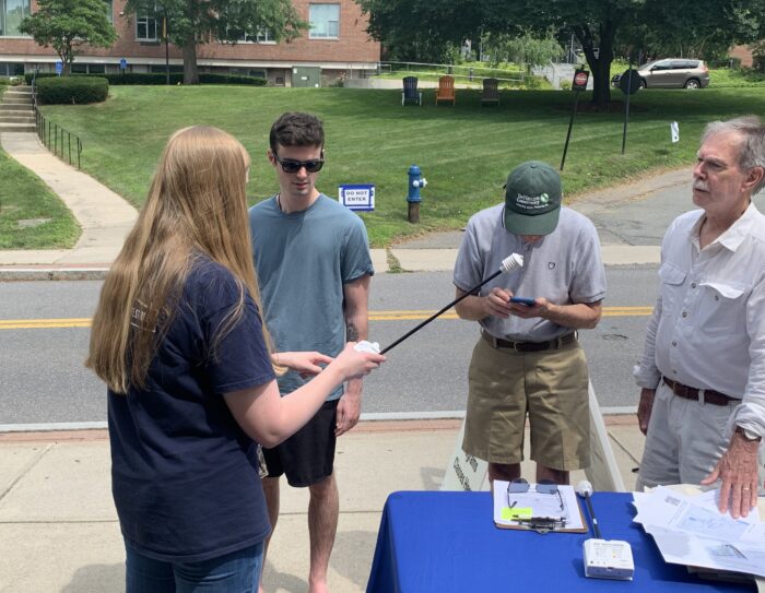 A photo of a volunteer picking up the sensors at FSU and an FSU member is demonstrating how to use the sensor.