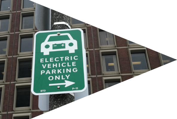 A photo of a street sign that says "Electric Vehicle Parking Only"