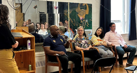 Cambridge Community Center_Climate Change and Social Resilience_May 2024 A photo of four people sitting in chairs as a panel on social resilience projects in Cambridge.