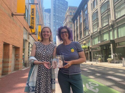 Annis & Lindsay NARC award A photo of MAPC Director of Arts of Culture Culture Annis Sengupta standing next to Senior Regional Humanities Specialist Lindsay Randall on a Boston street with the NARC Major Metro Award.