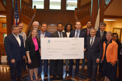DSC_0195 A photo of people gathered around the HUD PRO Housing grant check from the July 2 event.