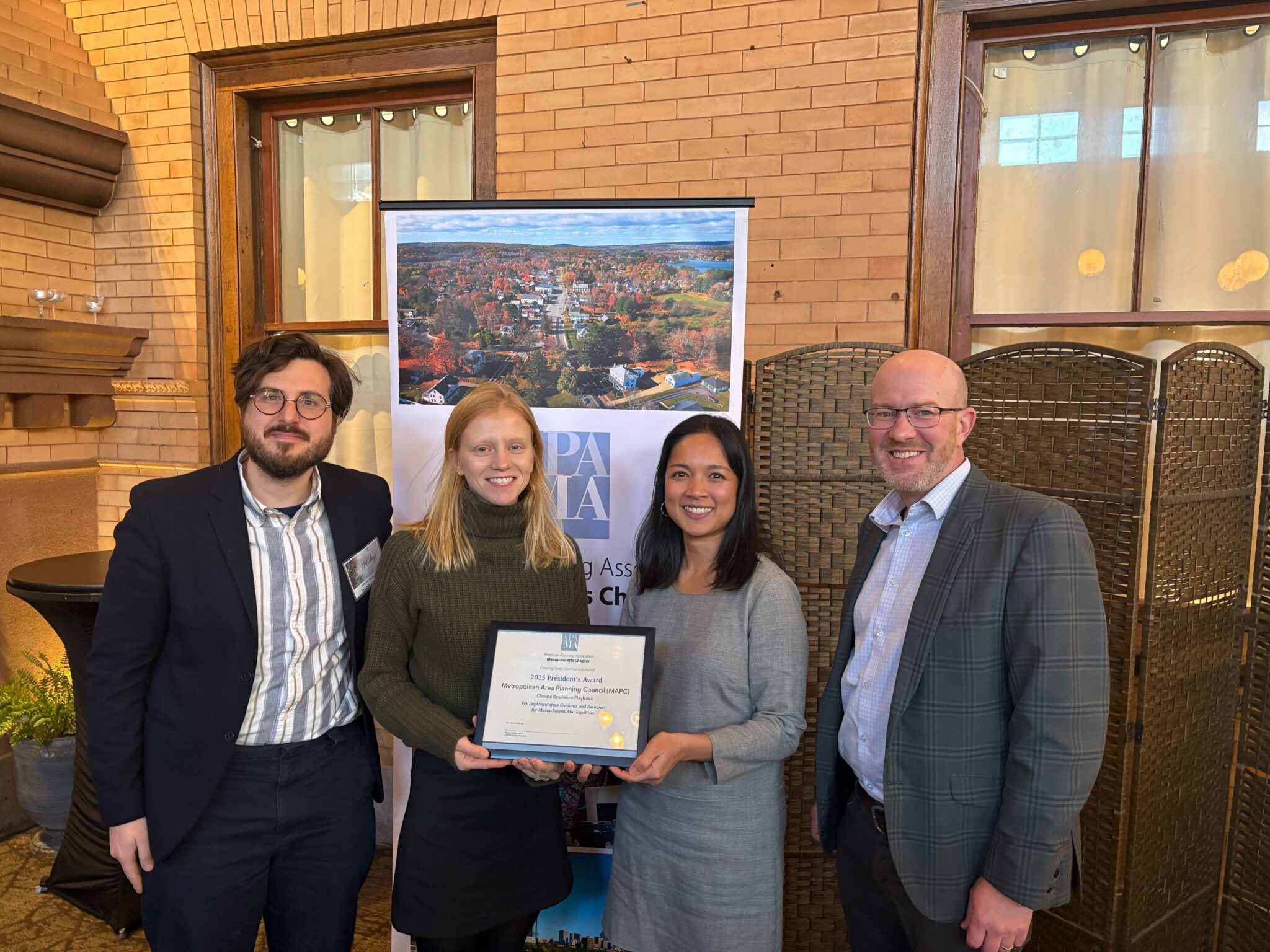 MAPC staff from left to right: Stephen Larrick, Digital Services Manager; Emma Zehner, Senior Clean Energy and Climate Planner; Van Du, Director of Environmental Planning; and Eric Hove, Director of Strategic Initiatives. Emma and Van are holding the President's Award.