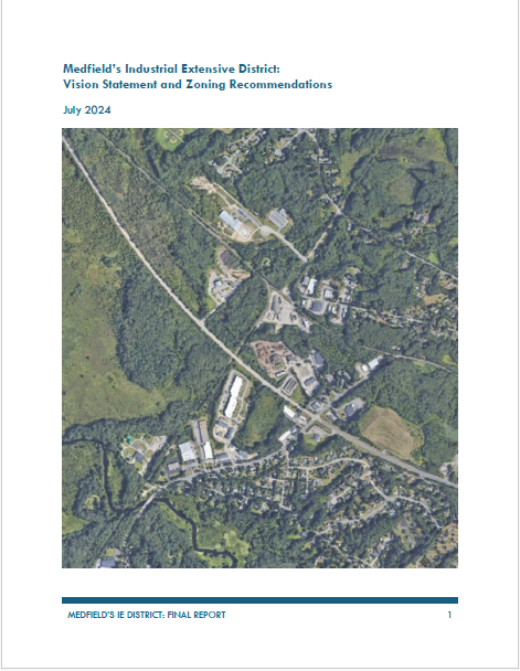 On a white background, a large square photo of an aerial view of Medfield. Above the photo in blue text it says, "Medfield's Industrial Extensive District: Vision Statement and Zoning Recommendations. July 2024." Under the photo in blue text it says, "Medfield's IE District: Final Report."