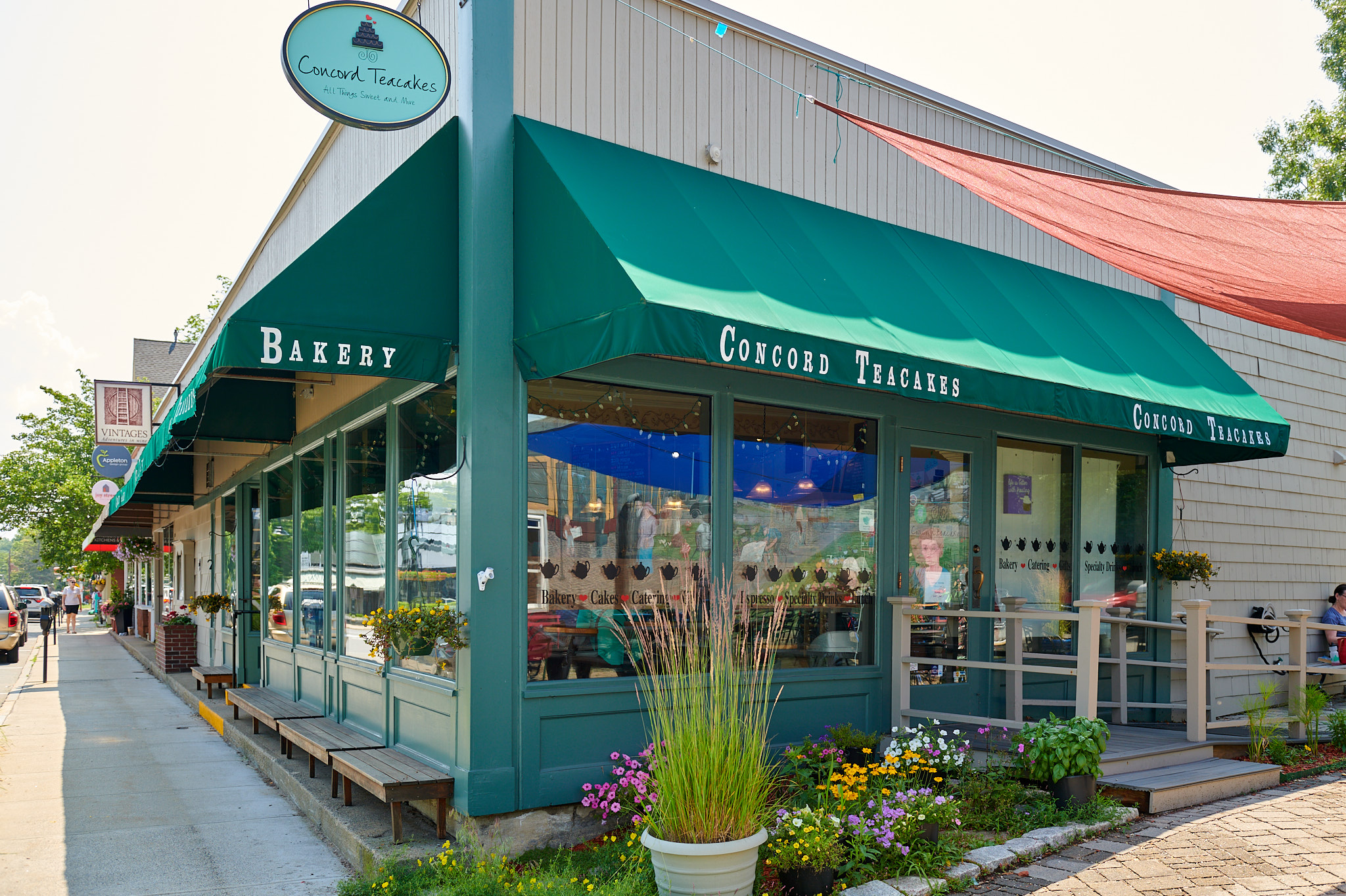 _DSC4755_Concord age-friendly business flyer Photo of a business in Concord. The building is grey with a green awning. In white letters on the awning it says, Concord Teacakes.