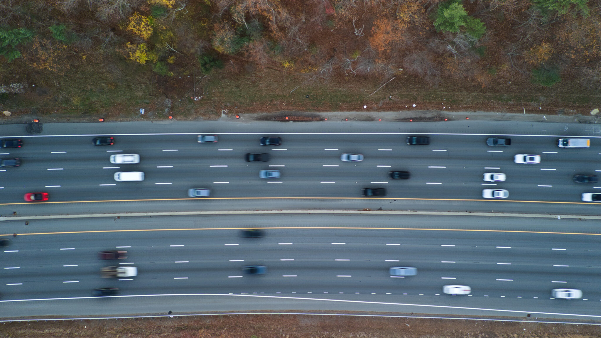 Aerial view of a multi-lane highway going both ways.