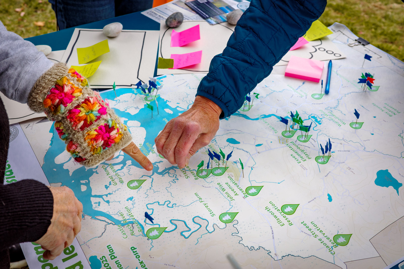 Picture of poster-size map of open space in Essex, with three hands pointing at different locations on the map. Photo credit: John Cruz.